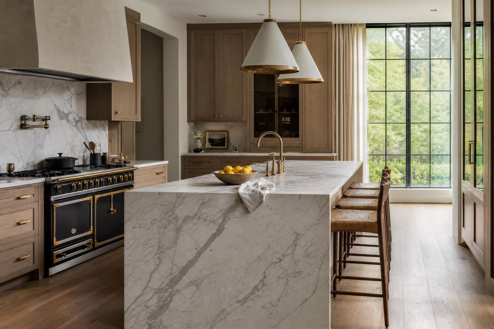 Designer kitchen with European oak cabinetry and marble waterfall island